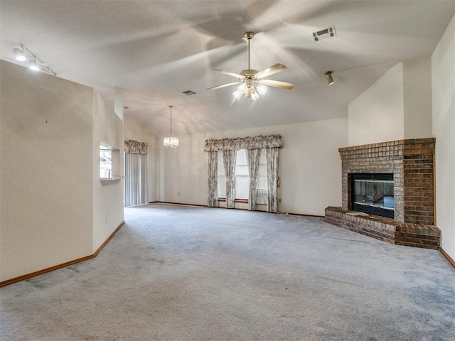 1717 Park View Pl, Edmond, OK 73003 - unfurnished living room with carpet flooring, ceiling fan, a brick fireplace, lofted ceiling, and a chandelier