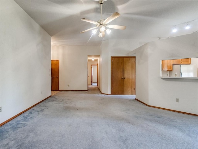 1717 Park View Pl, Edmond, OK 73003 - unfurnished living room featuring a ceiling fan, light carpet, and baseboards