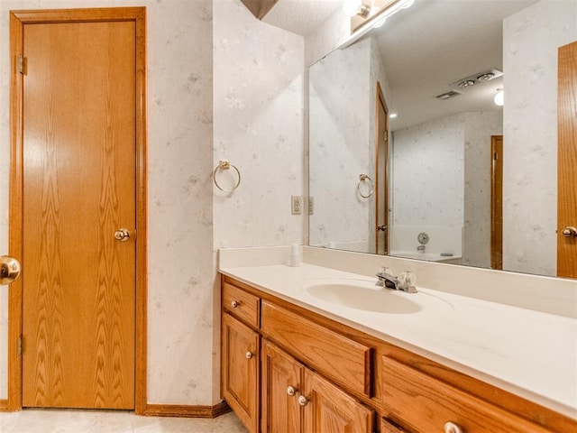 1717 Park View Pl, Edmond, OK 73003 - bathroom featuring wallpapered walls and vanity