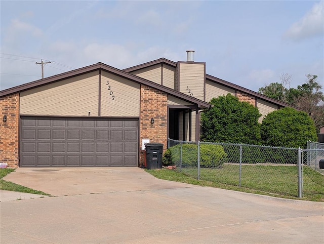 3207 Lois Arlene Cir, Moore, OK 73160 - view of front of house featuring fence, brick siding, and concrete driveway