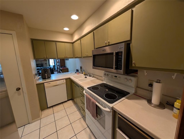 3207 Lois Arlene Cir, Moore, OK 73160 - kitchen featuring light tile patterned floors, a sink, white appliances, and light countertops