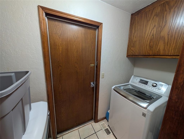 3207 Lois Arlene Cir, Moore, OK 73160 - laundry area with light tile patterned flooring, washer / clothes dryer, and cabinet space