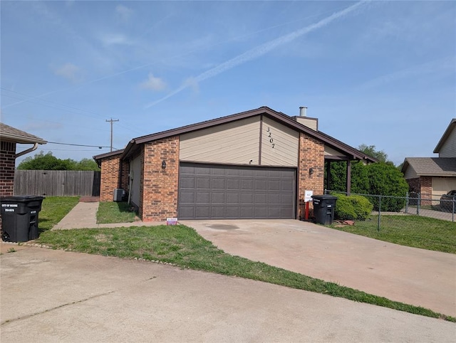 3207 Lois Arlene Cir, Moore, OK 73160 - view of front facade with fence, brick siding, a garage, and concrete driveway