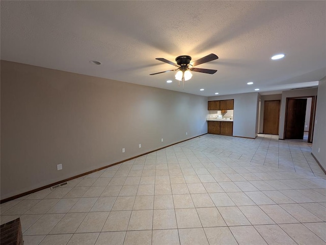 3207 Lois Arlene Cir, Moore, OK 73160 - unfurnished living room featuring a ceiling fan, a textured ceiling, baseboards, visible vents, and recessed lighting