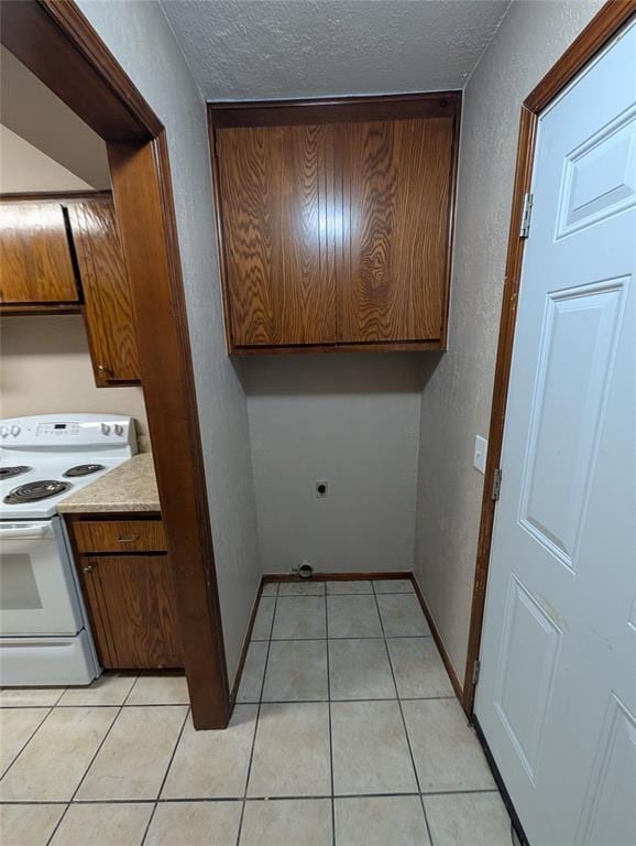3207 Lois Arlene Cir, Moore, OK 73160 - interior space with a textured ceiling, light tile patterned floors, a textured wall, cabinet space, and baseboards