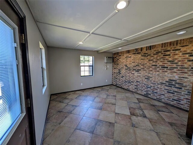 3207 Lois Arlene Cir, Moore, OK 73160 - empty room with a wall mounted AC, baseboards, and brick wall