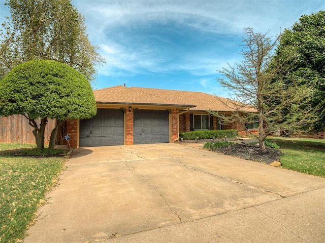 single story home with brick siding, driveway, fence, and a garage