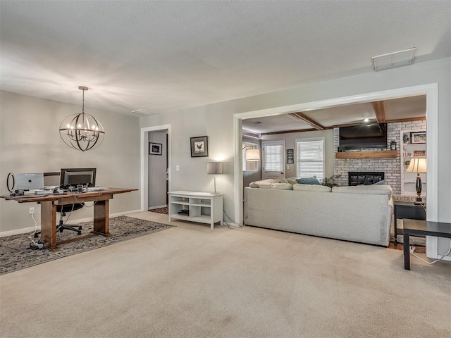 living area with visible vents, a brick fireplace, carpet floors, and a notable chandelier