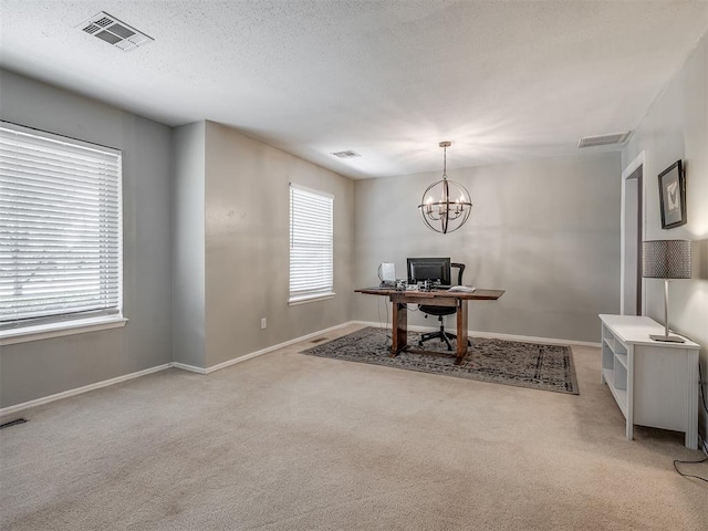 office space with light colored carpet, baseboards, visible vents, and an inviting chandelier
