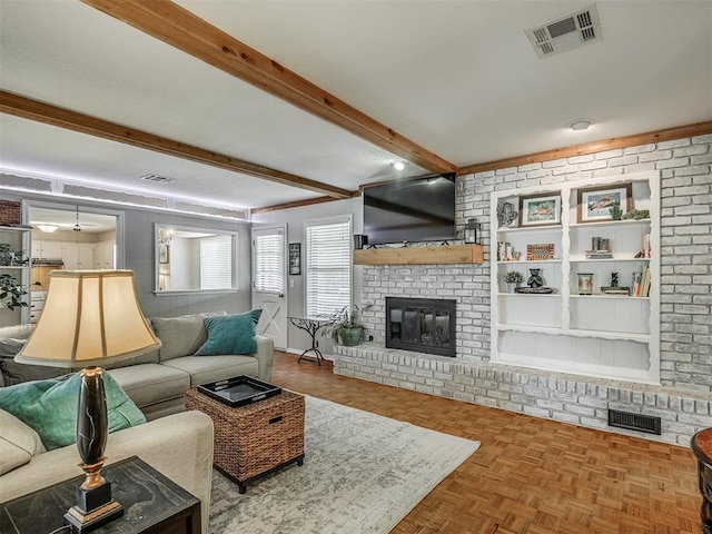 living room featuring visible vents, a brick fireplace, and beam ceiling