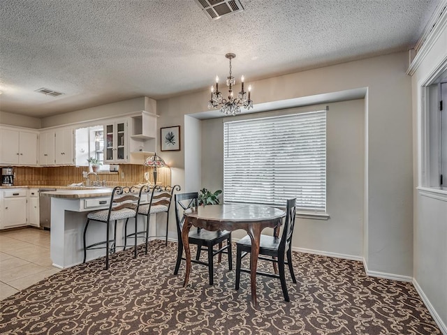dining space with a chandelier, visible vents, and a wealth of natural light
