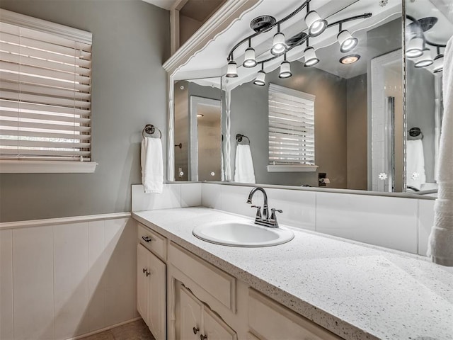 bathroom featuring vanity and a wainscoted wall