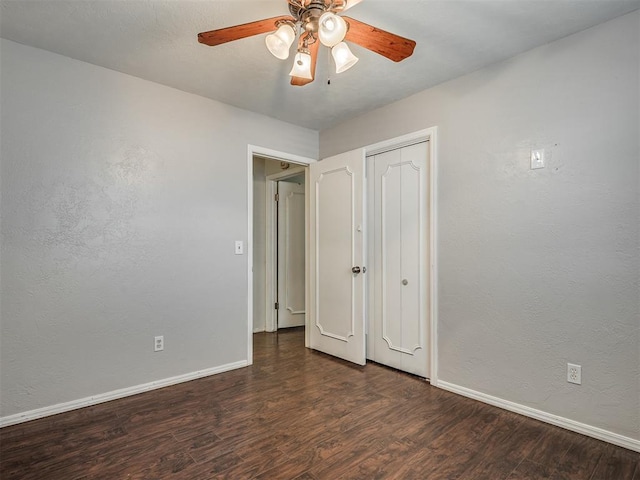 unfurnished bedroom with a ceiling fan, baseboards, wood finished floors, and a closet
