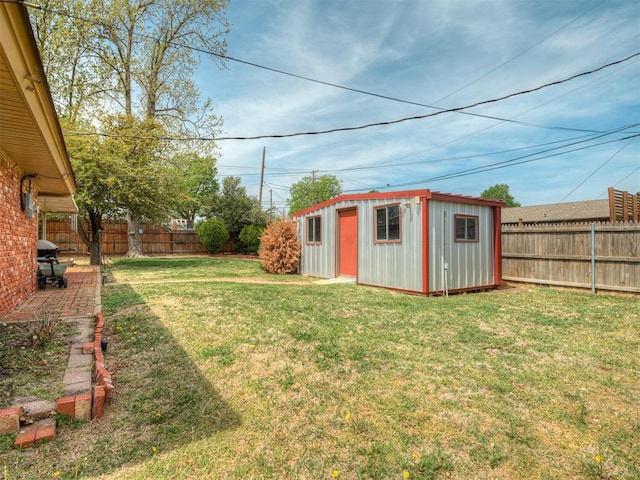 view of yard with a fenced backyard, an outbuilding, and a storage shed
