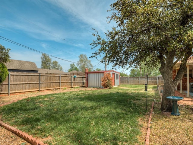 view of yard featuring a fenced backyard, an outdoor structure, and a shed