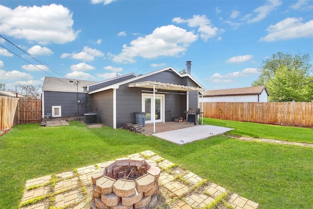 113 Central Dr, Sayre, OK 73662 - back of house featuring french doors, a fenced backyard, a yard, a patio, and an outdoor fire pit