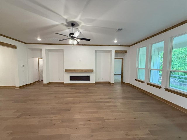 unfurnished living room featuring baseboards, visible vents, a ceiling fan, and crown molding