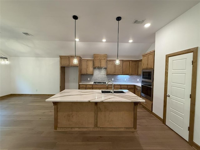 kitchen with a sink, visible vents, brown cabinetry, and oven
