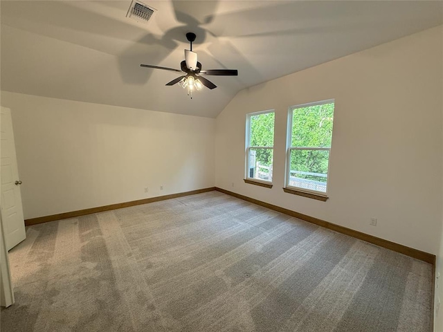 interior space featuring visible vents, ceiling fan, vaulted ceiling, and carpet