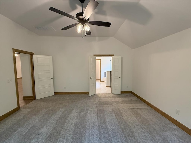 unfurnished bedroom with visible vents, baseboards, lofted ceiling, and carpet floors