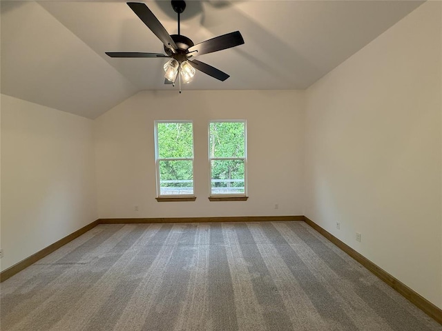 unfurnished room with baseboards, ceiling fan, lofted ceiling, and carpet flooring