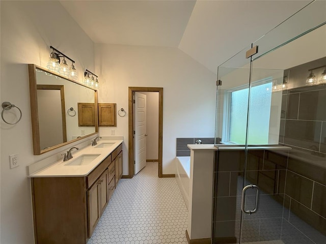 full bathroom with a shower stall, double vanity, vaulted ceiling, a bath, and a sink