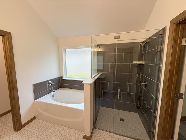 bathroom featuring a garden tub, tile patterned flooring, a shower stall, and vaulted ceiling