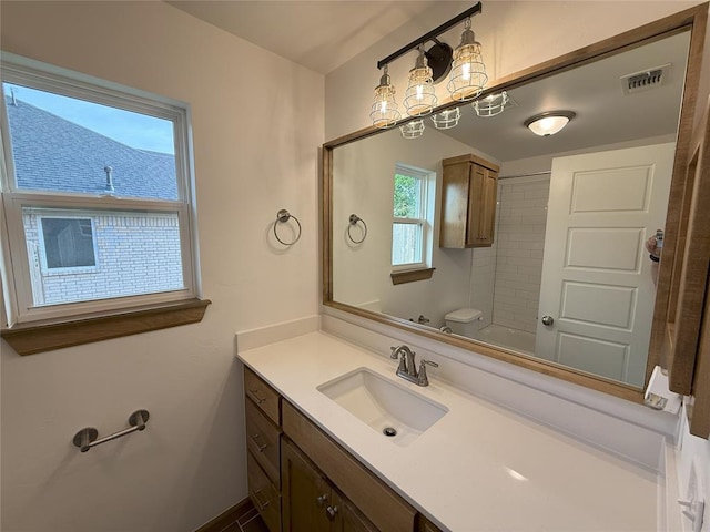 full bath with toilet, visible vents, walk in shower, and vanity