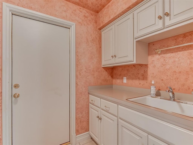 13504 Fox Creek Dr, Oklahoma City, OK 73131 - kitchen featuring a sink, light countertops, light tile patterned floors, and white cabinetry
