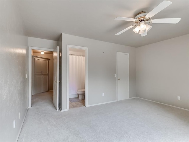 13504 Fox Creek Dr, Oklahoma City, OK 73131 - unfurnished bedroom featuring light colored carpet, connected bathroom, baseboards, and a ceiling fan