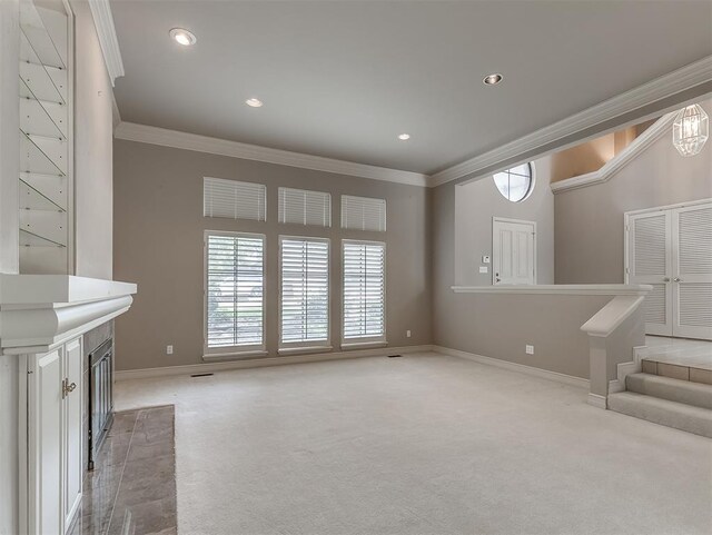 13504 Fox Creek Dr, Oklahoma City, OK 73131 - unfurnished living room with ornamental molding, light colored carpet, baseboards, recessed lighting, and stairway