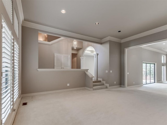 13504 Fox Creek Dr, Oklahoma City, OK 73131 - carpeted empty room with decorative columns, ornamental molding, arched walkways, baseboards, and stairs