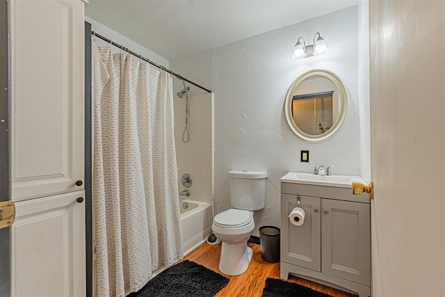 bathroom featuring toilet, vanity, wood finished floors, and shower / bathtub combination with curtain
