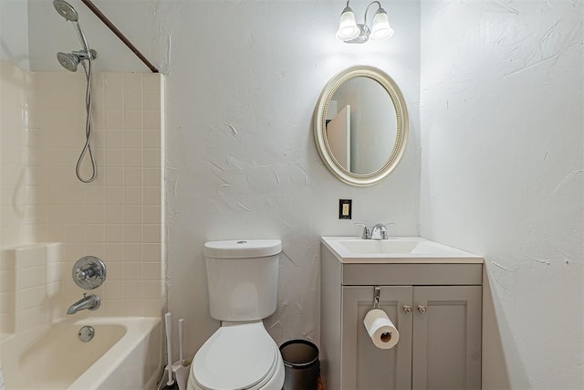 bathroom featuring toilet, vanity, and bathtub / shower combination