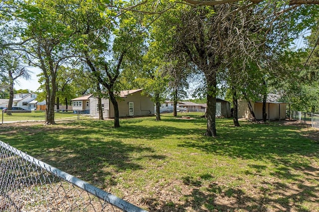 view of yard featuring a fenced backyard, an outdoor structure, and a storage shed
