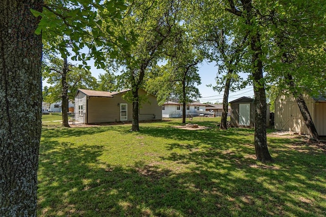 view of yard with a storage unit and an outbuilding