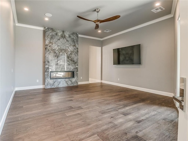 6105 NW 147th Ter, Oklahoma City, OK 73142 - unfurnished living room with crown molding, a ceiling fan, wood finished floors, and visible vents