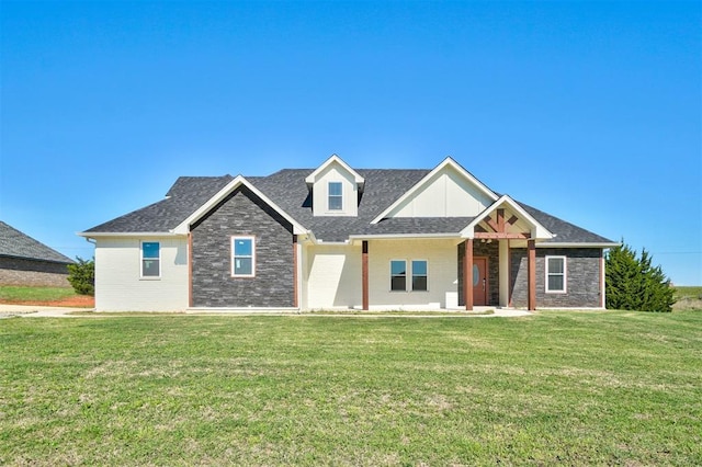 craftsman-style house featuring brick siding, roof with shingles, and a front yard