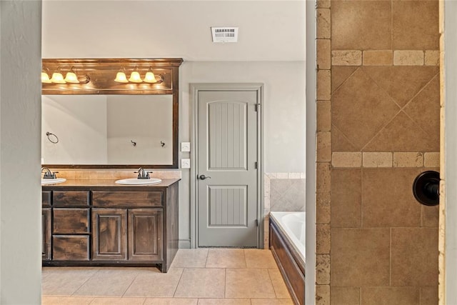 2828 Ryder Dr, Yukon, OK 73099 - full bath featuring a sink, double vanity, tile patterned floors, visible vents, and a bath