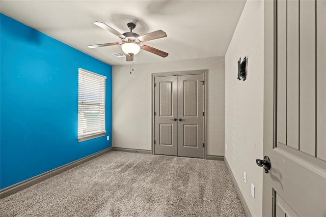2828 Ryder Dr, Yukon, OK 73099 - unfurnished bedroom featuring carpet flooring, ceiling fan, baseboards, visible vents, and a closet