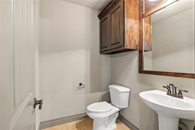 2828 Ryder Dr, Yukon, OK 73099 - bathroom featuring a sink, tile patterned floors, and toilet