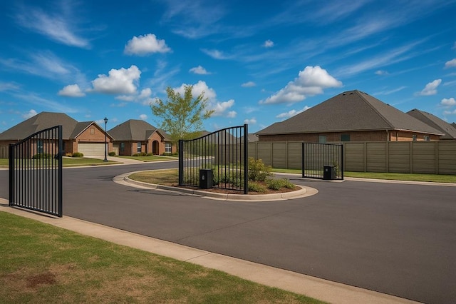 2828 Ryder Dr, Yukon, OK 73099 - view of road with a gated entry, a gate, and curbs