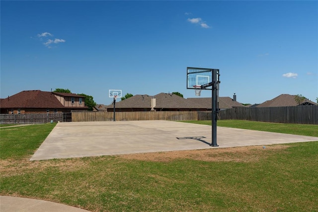 2828 Ryder Dr, Yukon, OK 73099 - view of basketball court with a lawn, a fenced backyard, and basketball hoop