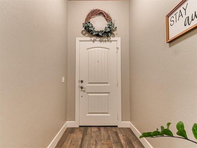 entryway with baseboards and dark wood finished floors