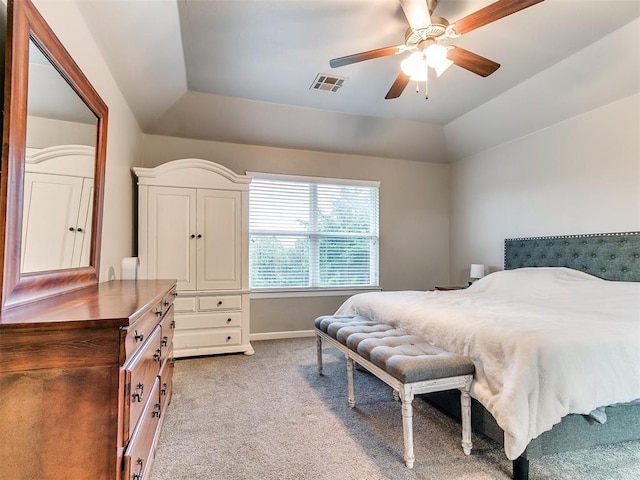 bedroom featuring ceiling fan, light colored carpet, baseboards, vaulted ceiling, and visible vents
