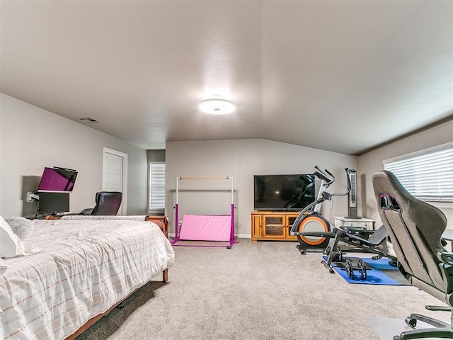 bedroom with carpet floors, baseboards, visible vents, and vaulted ceiling