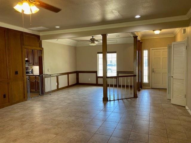 empty room featuring crown molding, ornate columns, ceiling fan, baseboards, and recessed lighting