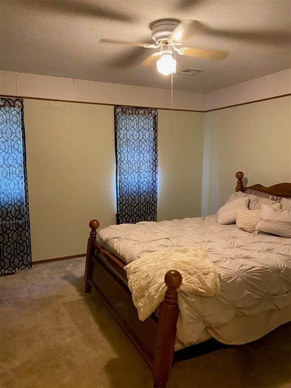 bedroom with ceiling fan and light carpet