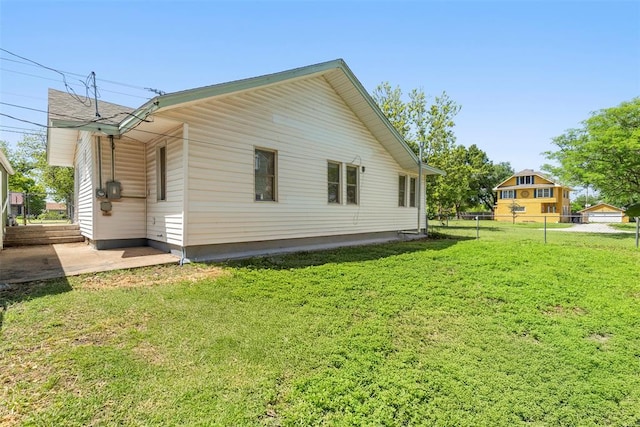 724 Maple St, Perry, OK 73077 - view of side of property featuring a yard, a patio, and fence