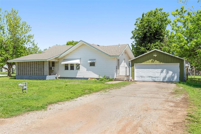 724 Maple St, Perry, OK 73077 - ranch-style home with a garage, an outbuilding, a front yard, and a shingled roof